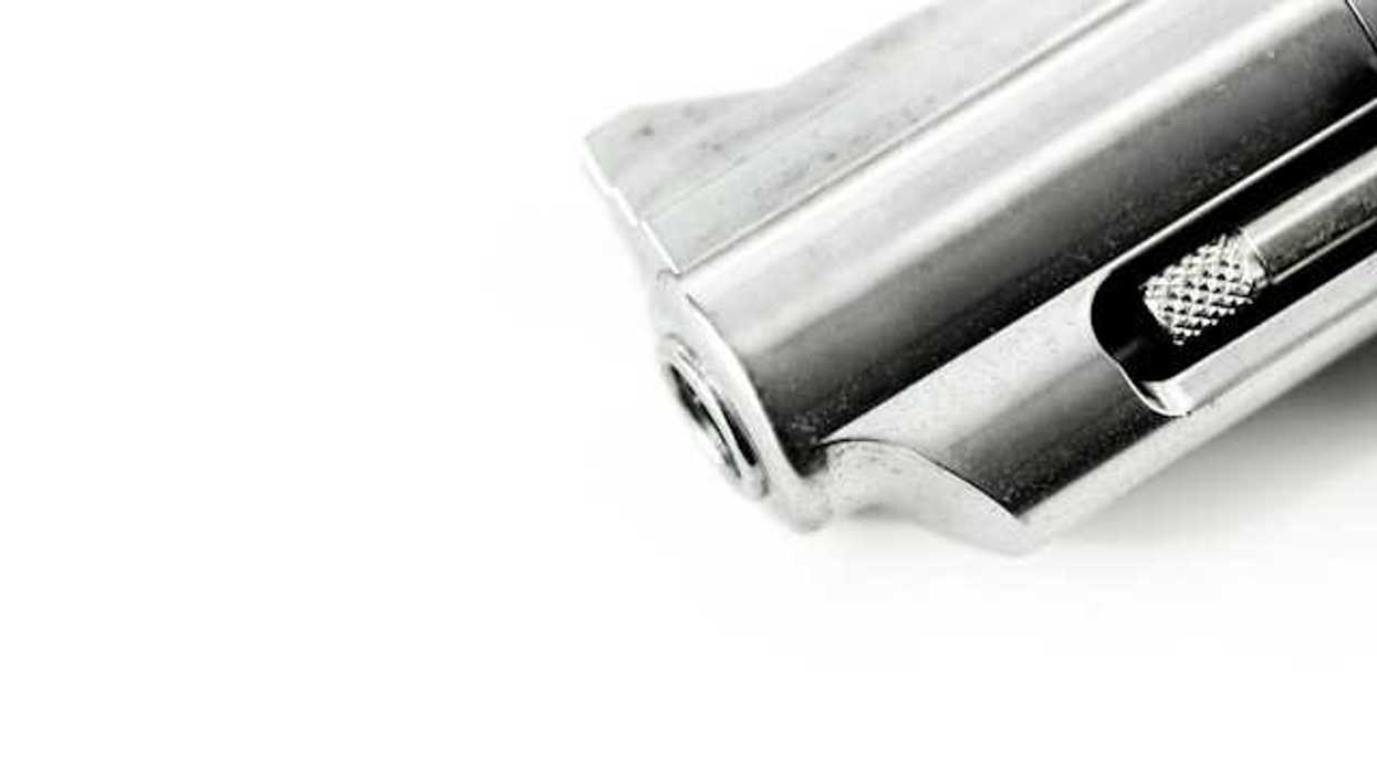 Closeup of a barrel of a gun on a white background