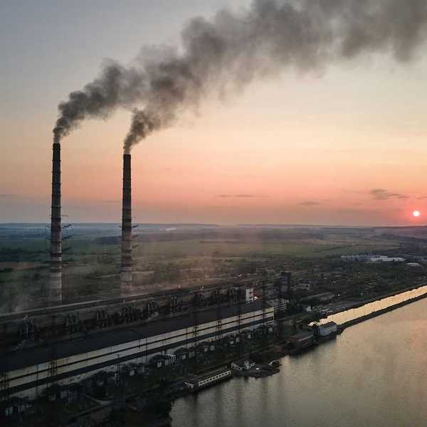 Coal power as exemplified by twin smokestacks emitting pollutants