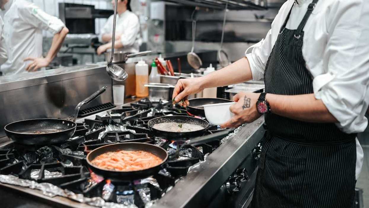 Commercial gas range in use in restaurant kitchen