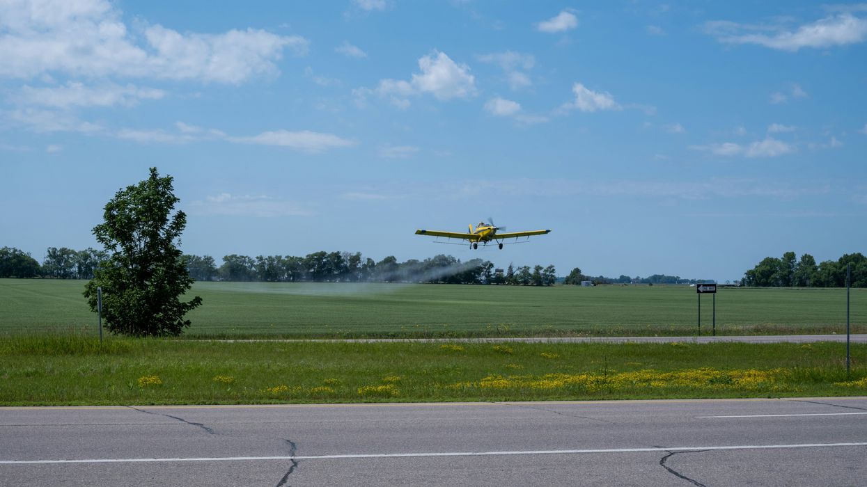 crop duster spraying a field pesticides