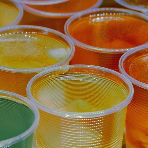 Cups with Jell-O gelatin dessert in orange, green and yellow.