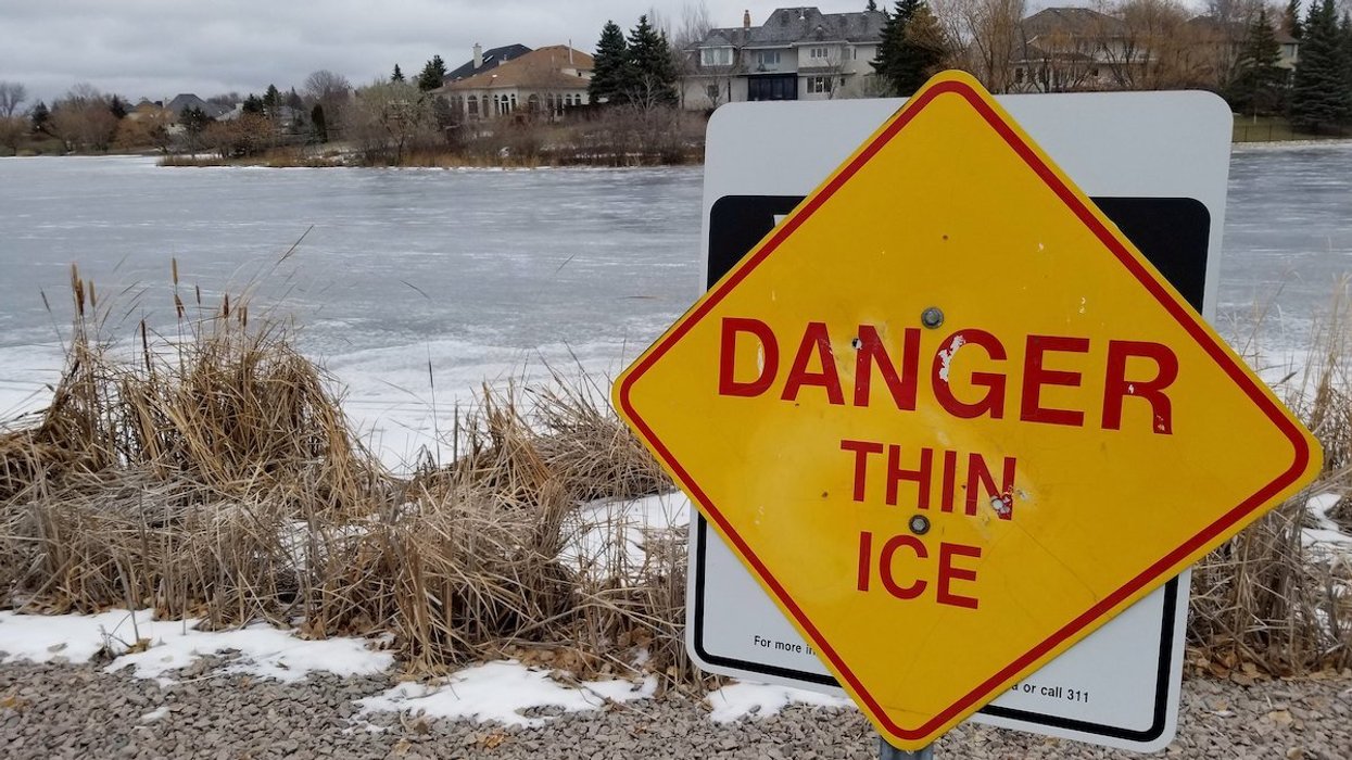 Danger Thing Ice sign near frozen lake