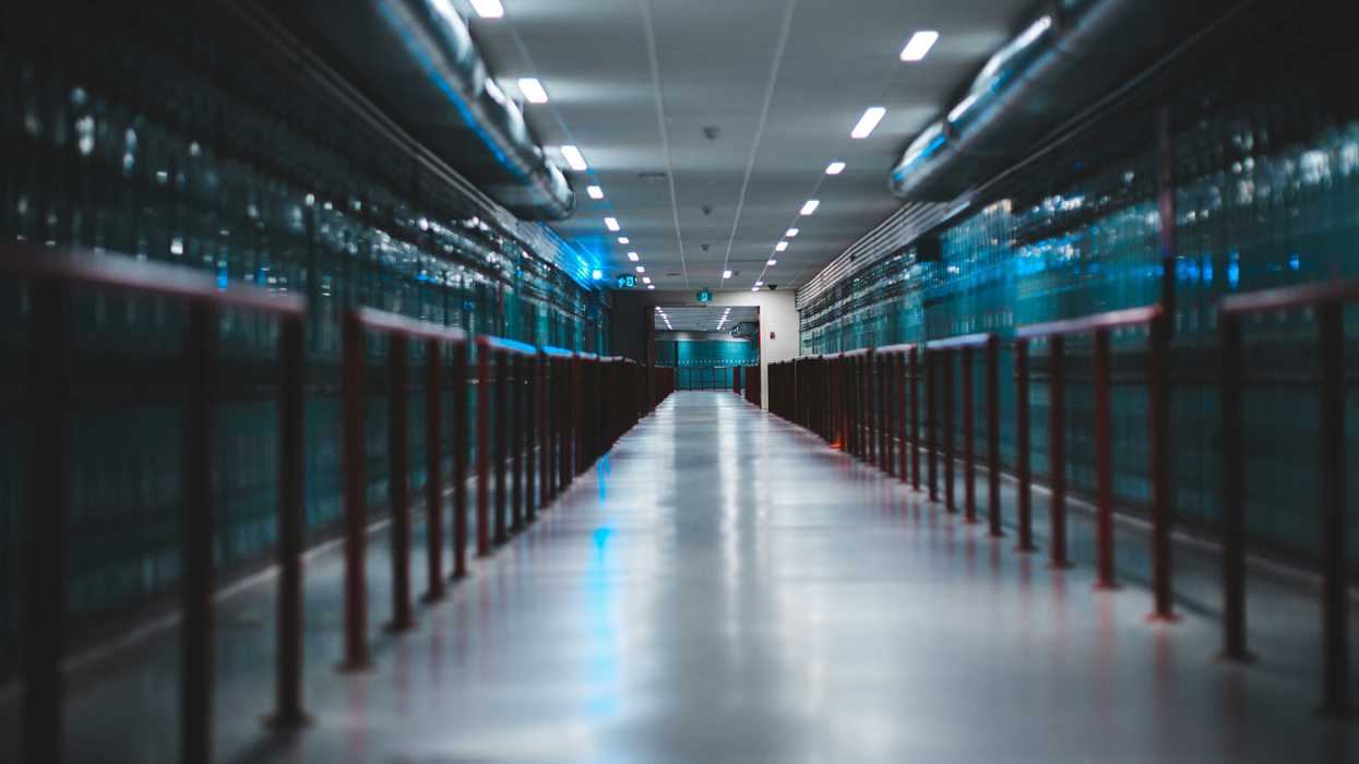 Data center interior with long aisles of computer equipment.