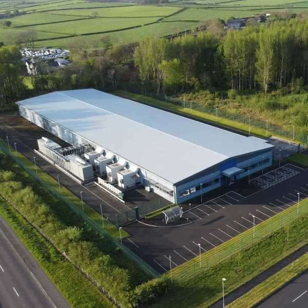 Data Center white industrial building in a green, bucolic rural setting