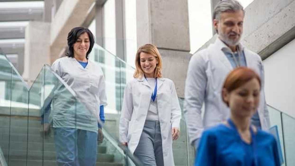 Doctors and nurses walking down a staircase in a hospital