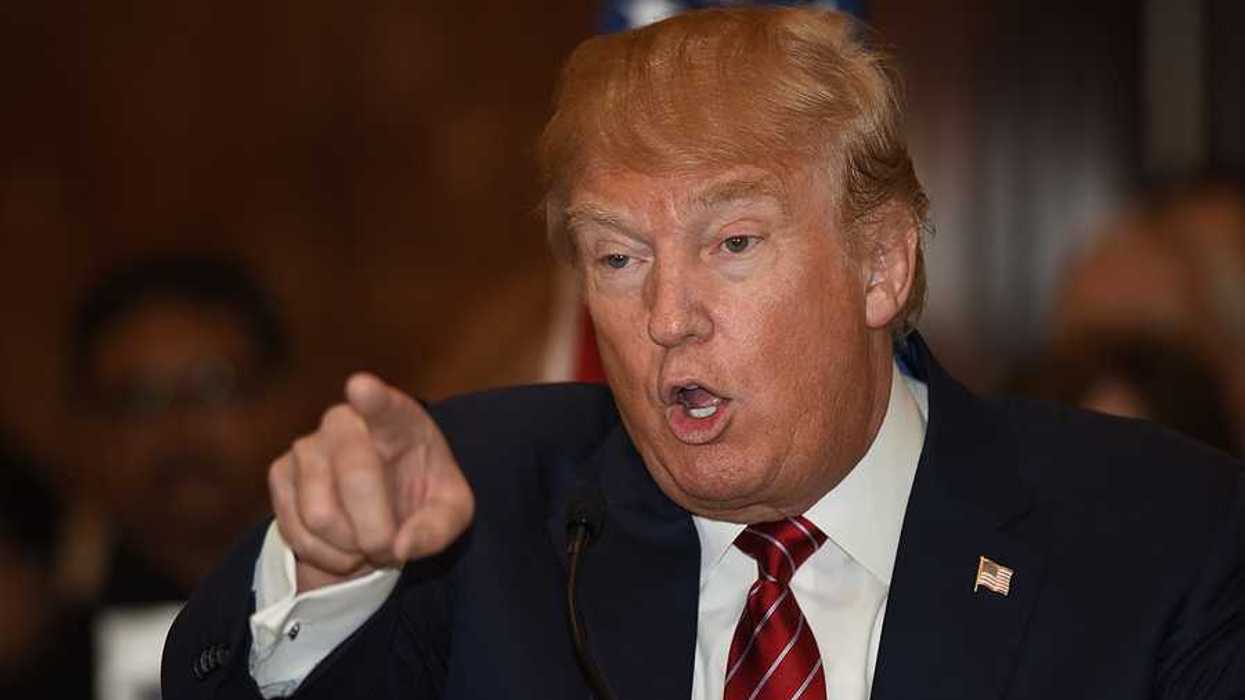 Donald Trump pointing finger and gesturing in a threatening manner