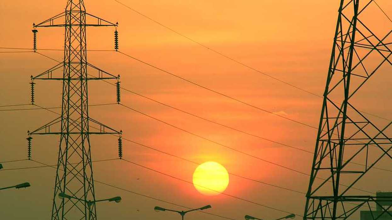 Electric towers with the sun in the background