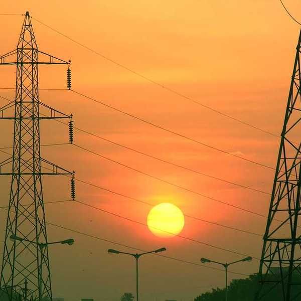 Electric towers with the sun in the background