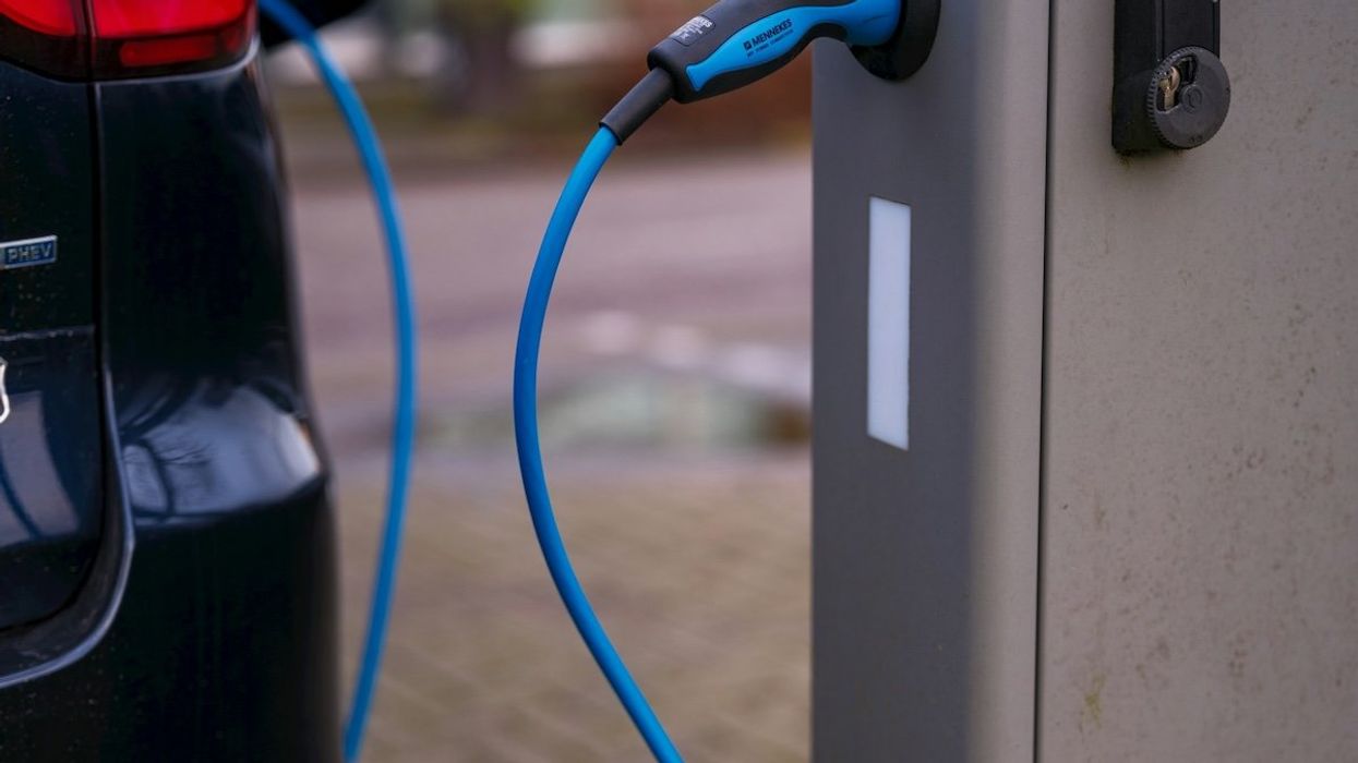Electric vehicle plugged into charging station