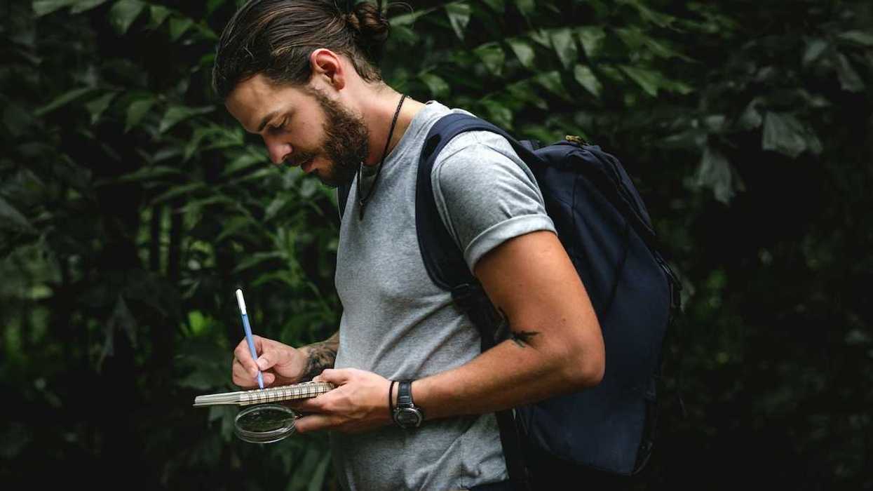 Field scientist recording notes in notebook