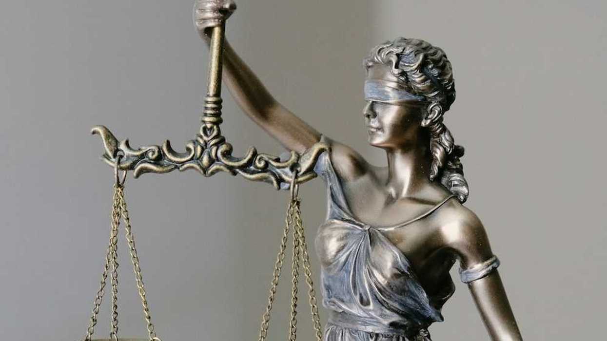Figure of "lady justice" holding scales of justice in right hand