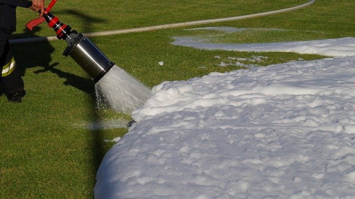 Firefighting foam being sprayed onto green gas