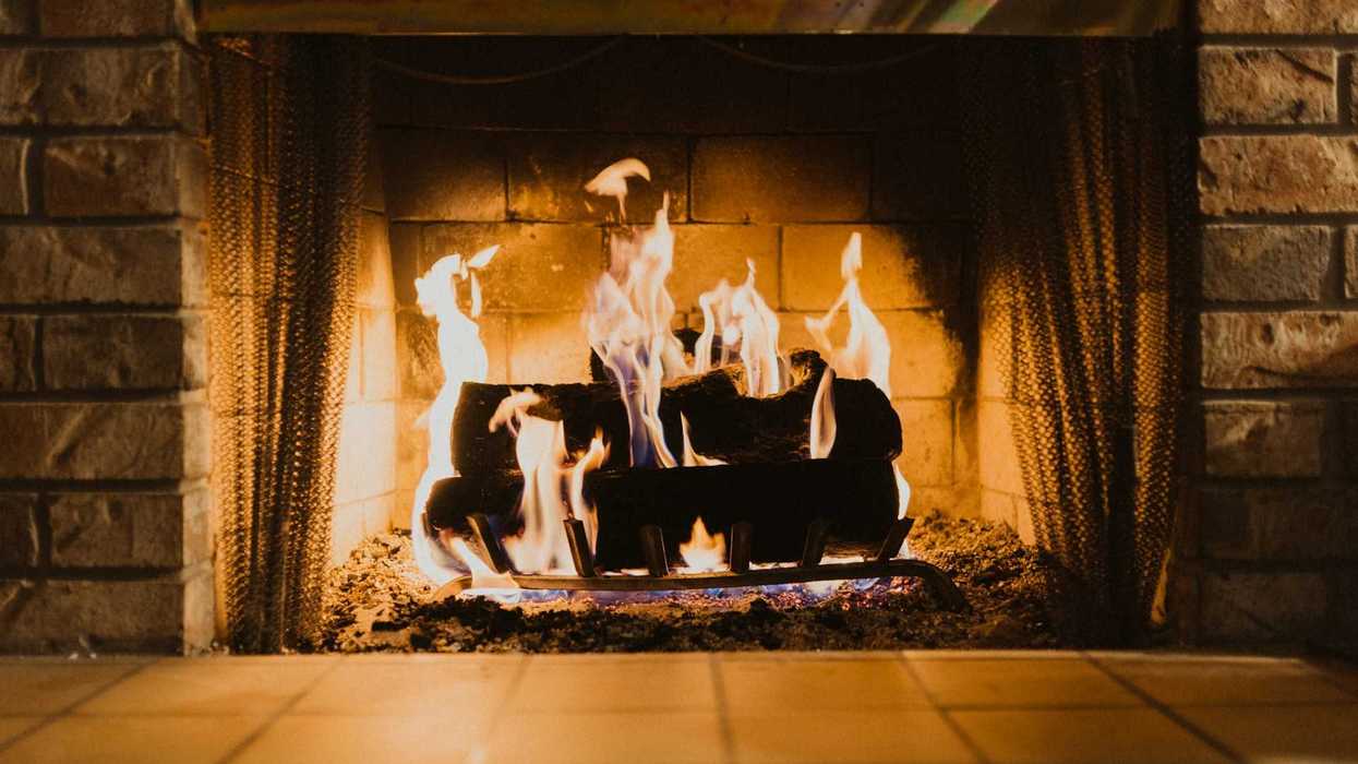 Firewood burning in an indoor fireplace