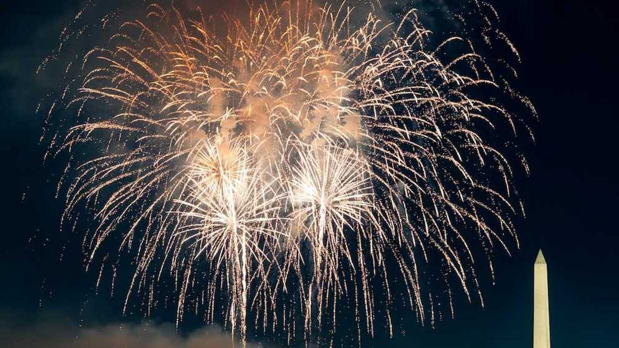 Fireworks burst over Washington, DC juxtaposed with Washington Monument