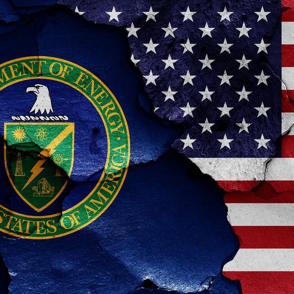 flags of Department of Energy and USA painted on cracked wall