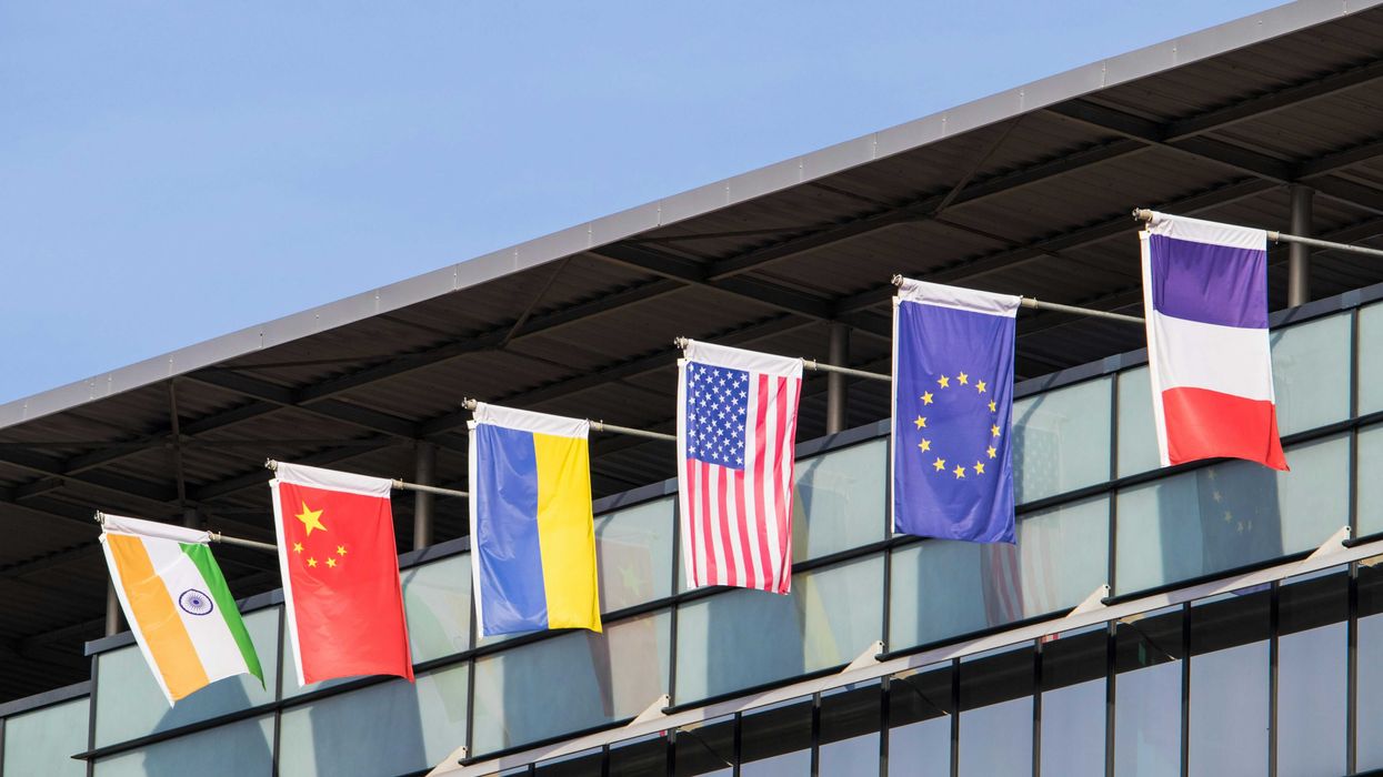 Flags of various nations fly on building