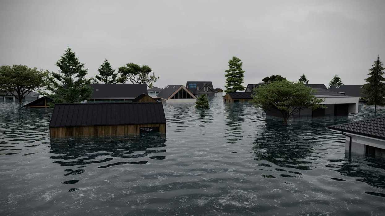 Flooded coastal neighborhood. Partially submerged homes and structures.