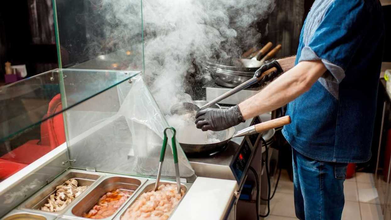 Food service line worker in a hot kitchen
