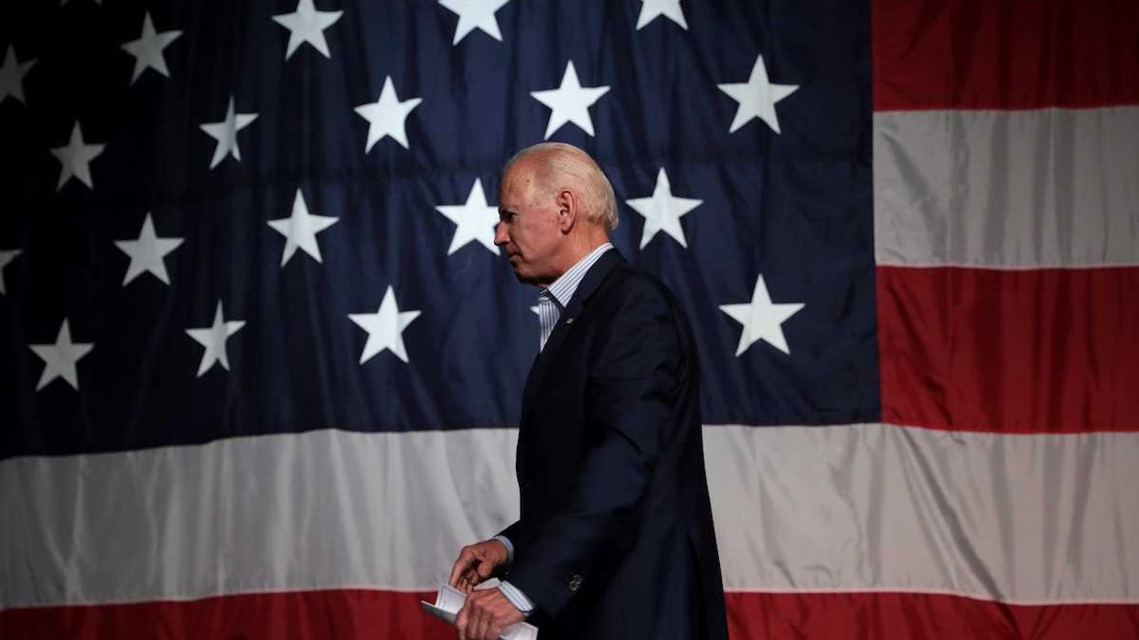 Former President of the United States Joe Biden with American flag backdrop