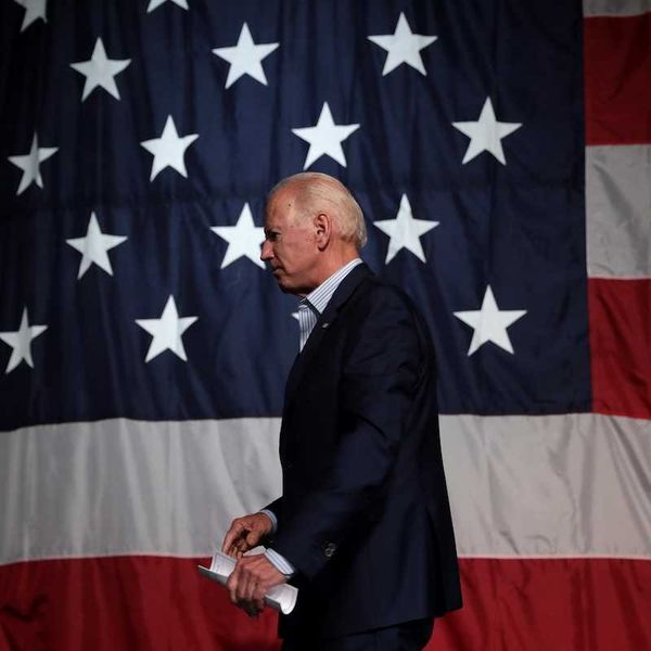 Former President of the United States Joe Biden with American flag backdrop