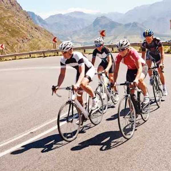 Four cyclists on a curvy mountain road