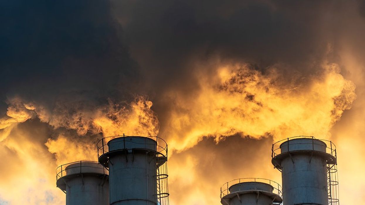 Four smokestacks billowing pollution