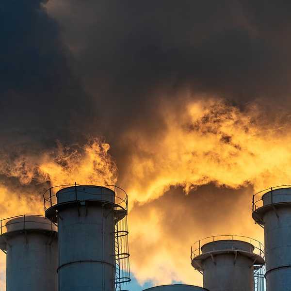 Four smokestacks billowing pollution