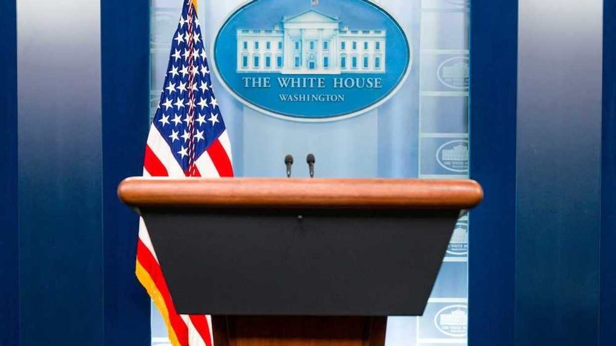 Free-standing lectern with American flag and White House logo as backdrop
