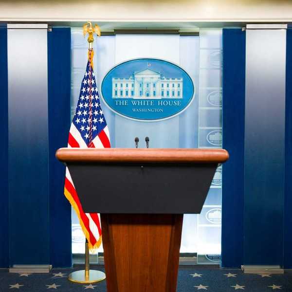 Free-standing lectern with American flag and White House logo as backdrop