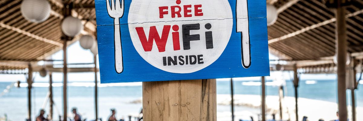 Free WiFi signage on wooden post