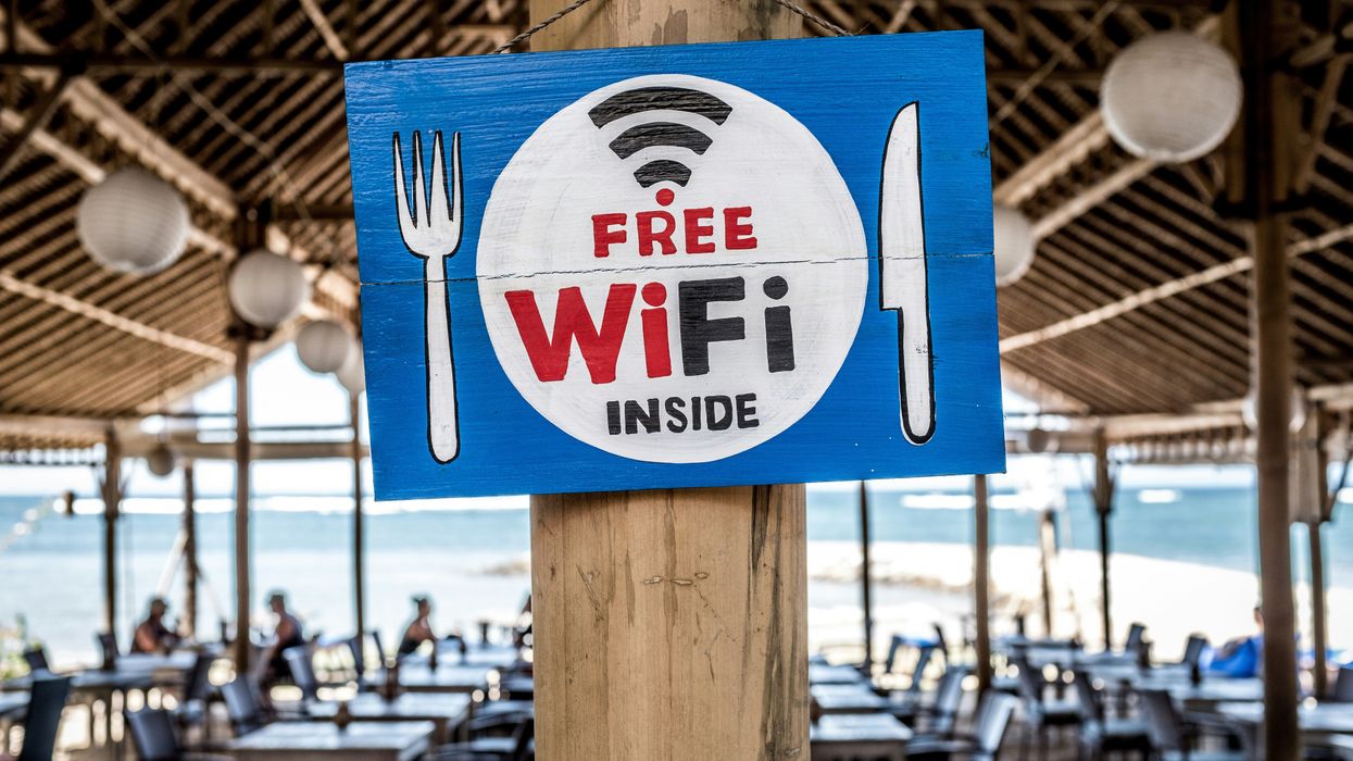Free WiFi signage on wooden post