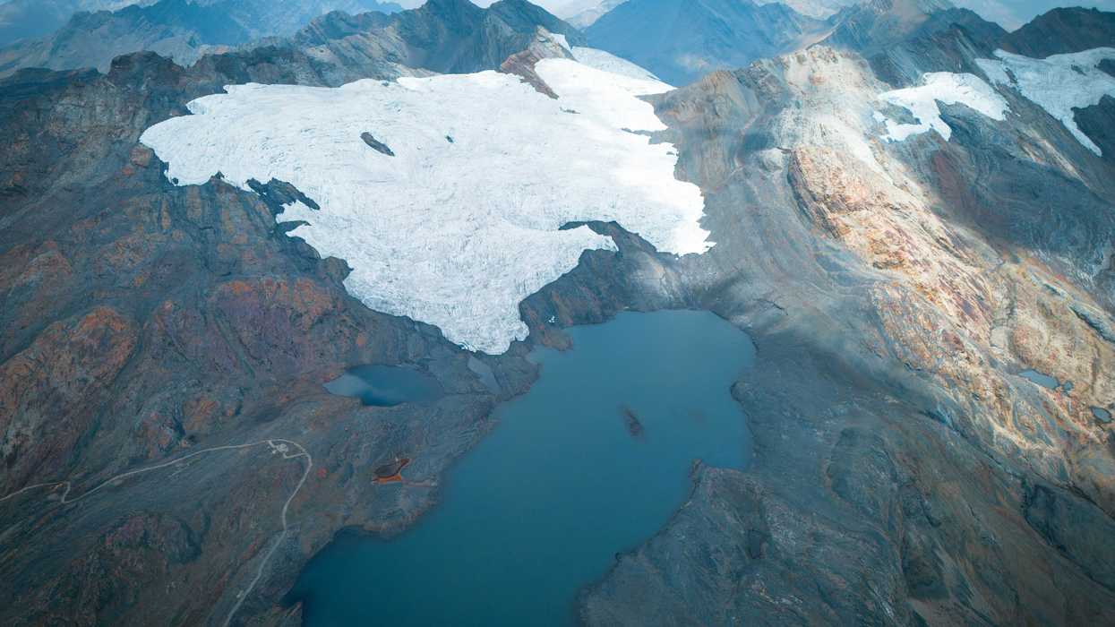 Glacier on a mountainside with lake below.