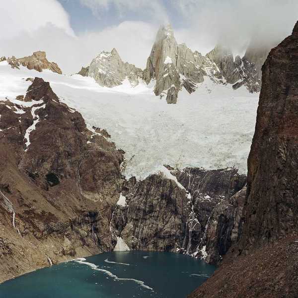 Glaciers hanging over an alpine lake formed by glacial meltwater