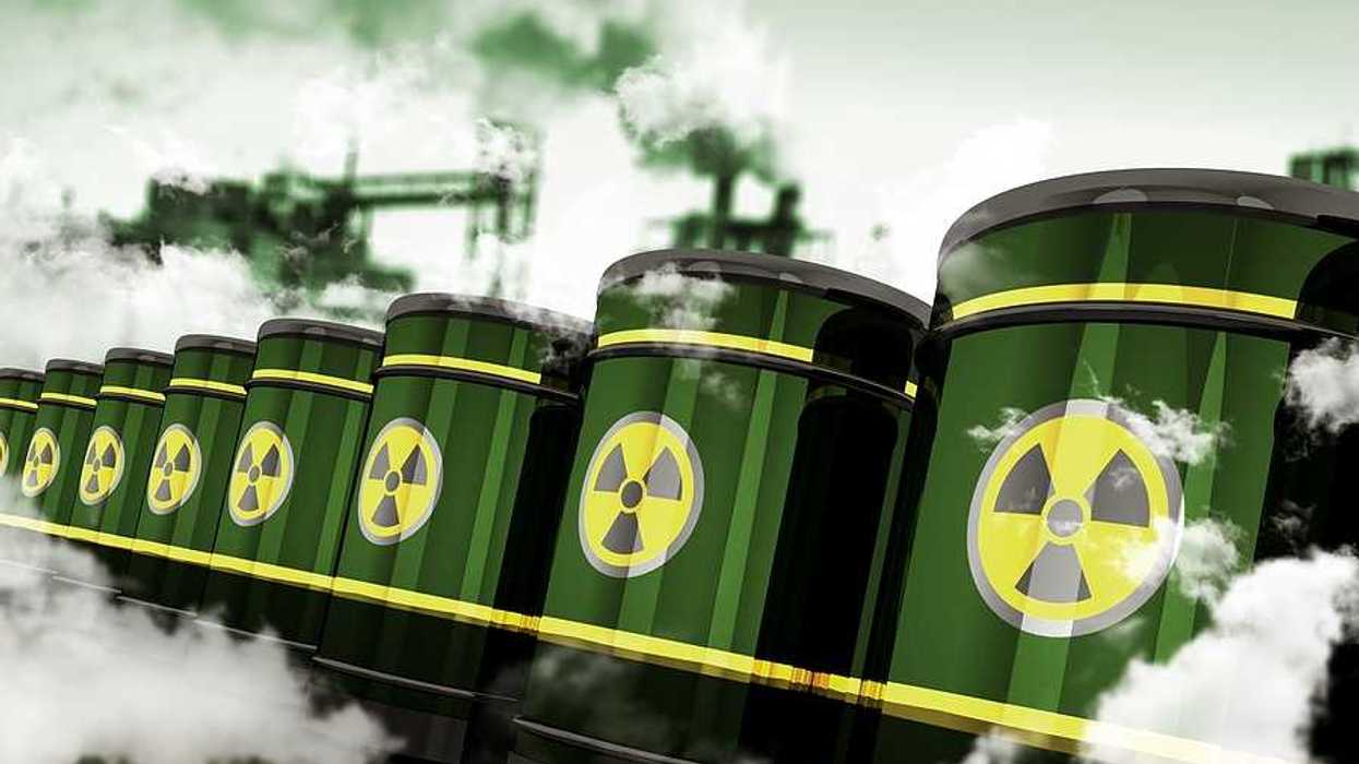 Green barrels with a radioactive sticker on them