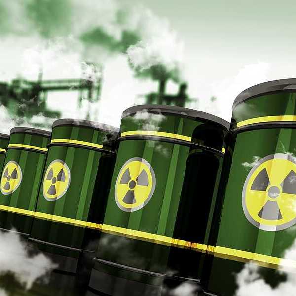 Green barrels with a radioactive sticker on them