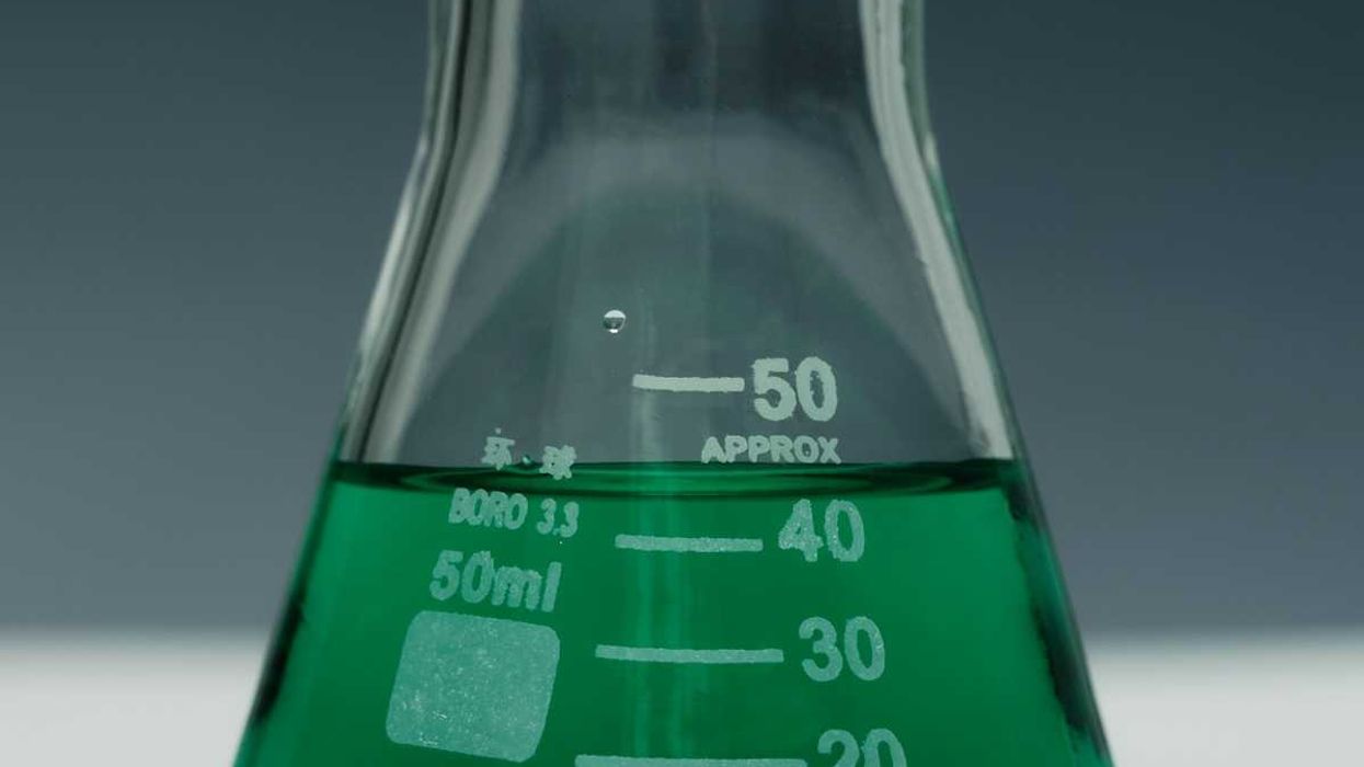 Green liquid in a glass beaker representing green chemistry
