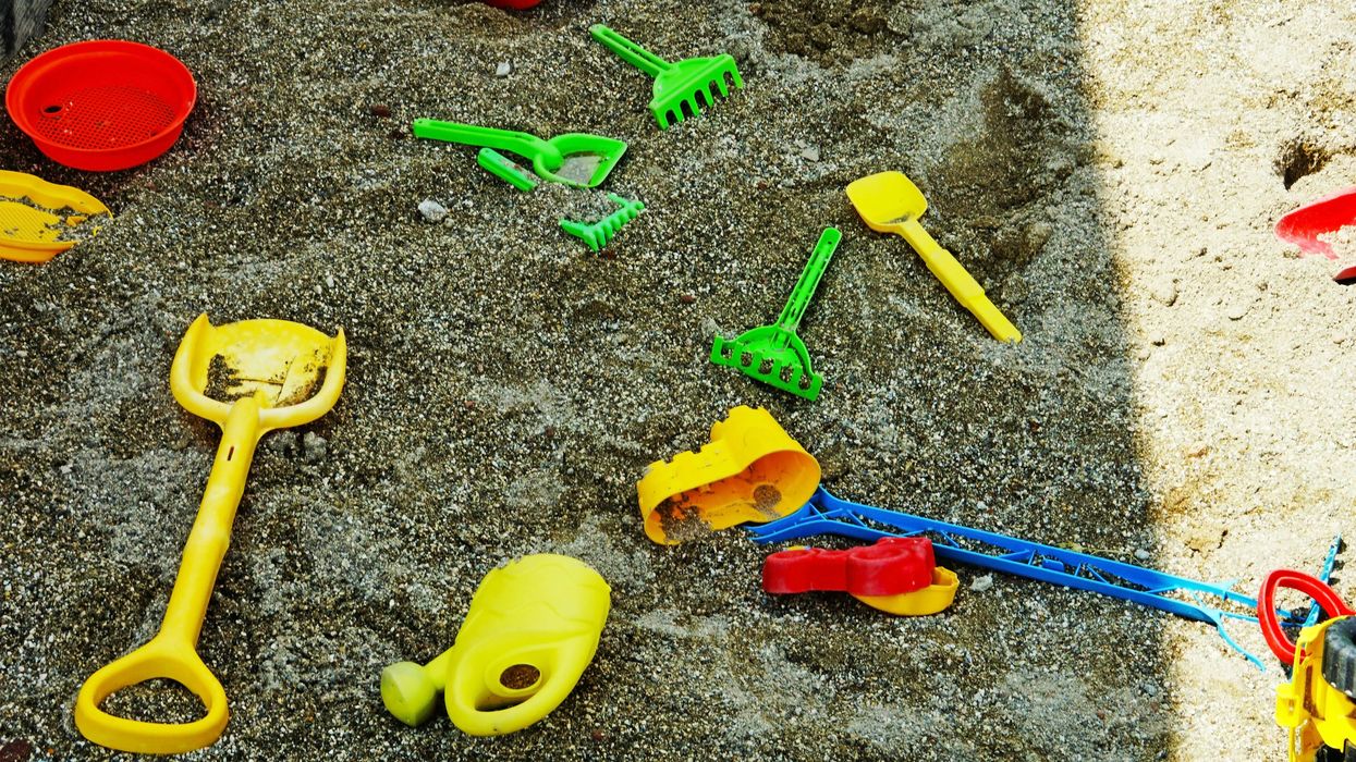 Green yellow and red plastic sandbox toys.