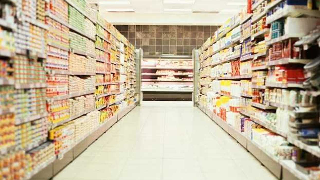 Grocery store aisle filled with shelves of non-perishable food