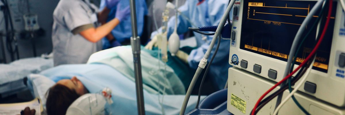 group of people doing a surgery on a person inside the operating room