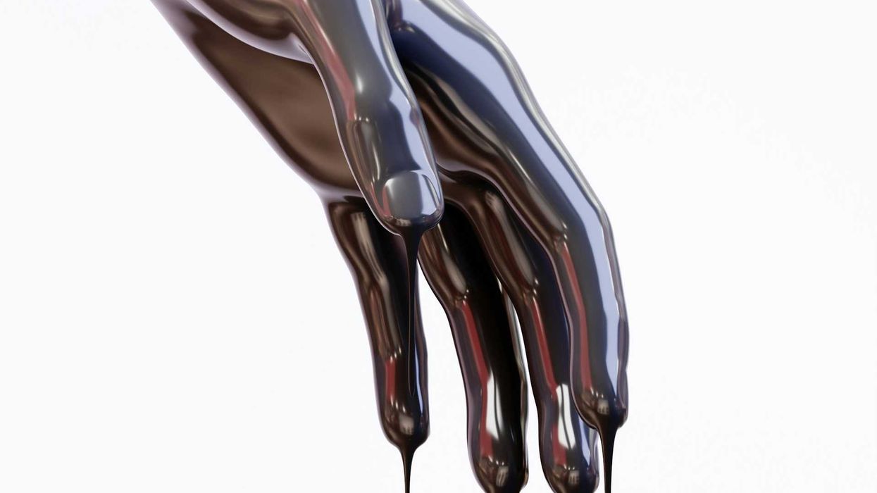 Hand covered in and dripping oil