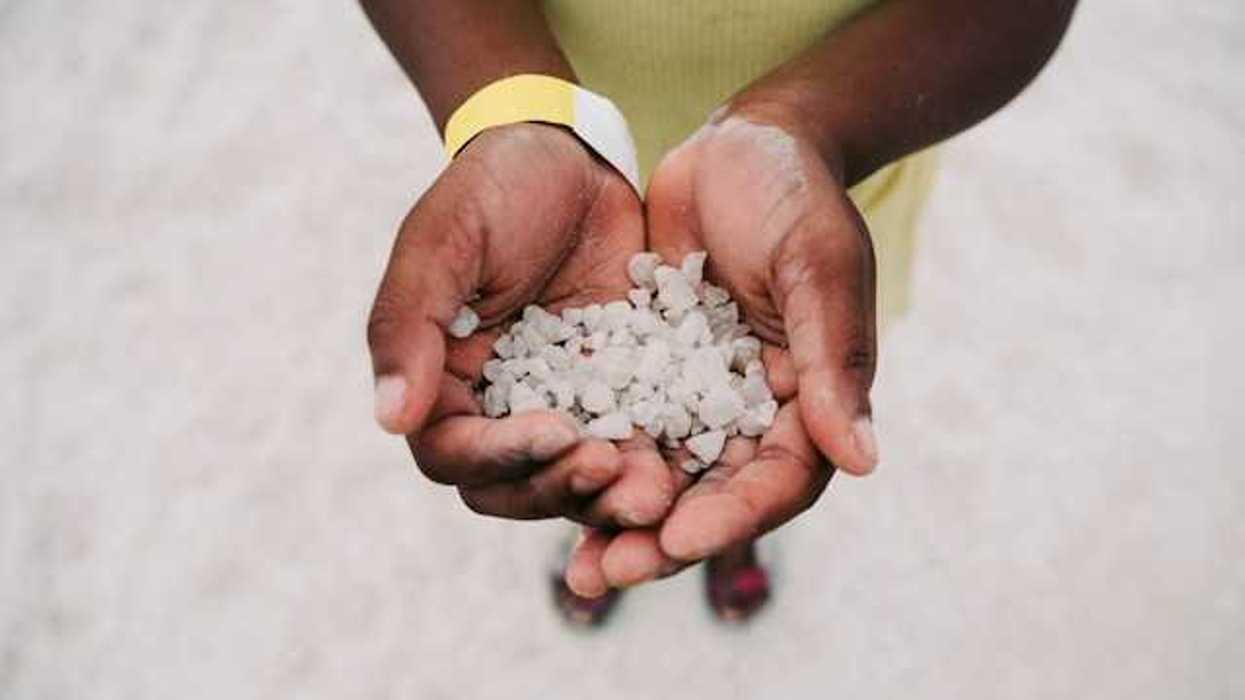Hands cupped holding many hail particles