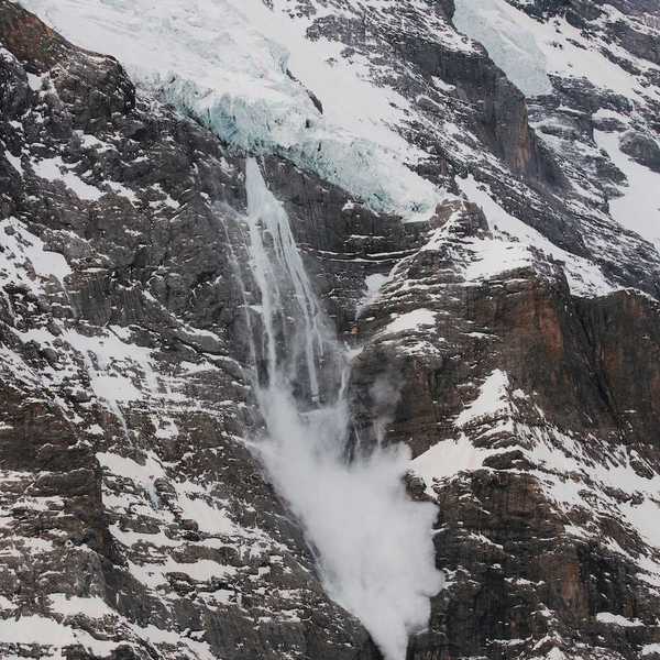 Hanging glacier with meltwater and snow sloughing from the tongue