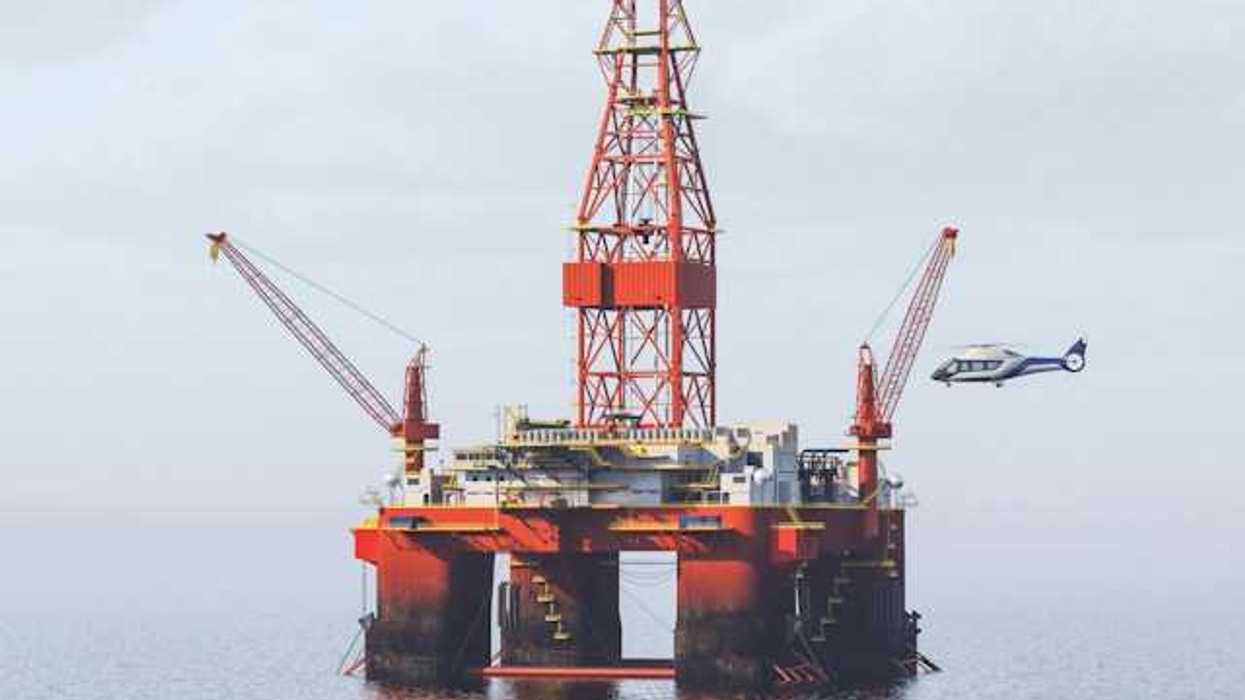 Helicopter landing on helipad at an offshore oil rig