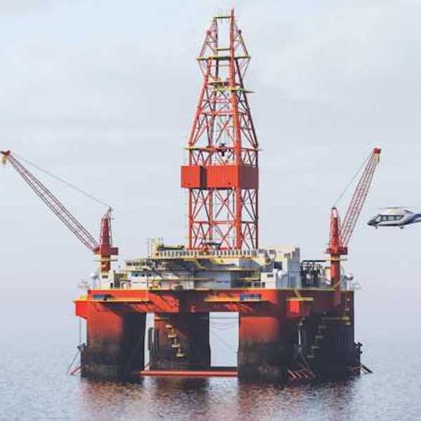 Helicopter landing on helipad at an offshore oil rig