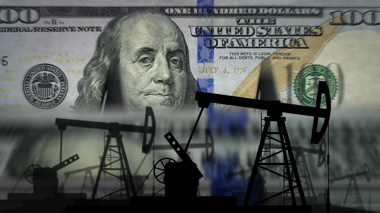 Hundred dollar bill in background with fossil fuel infrastructure shadows in front of it