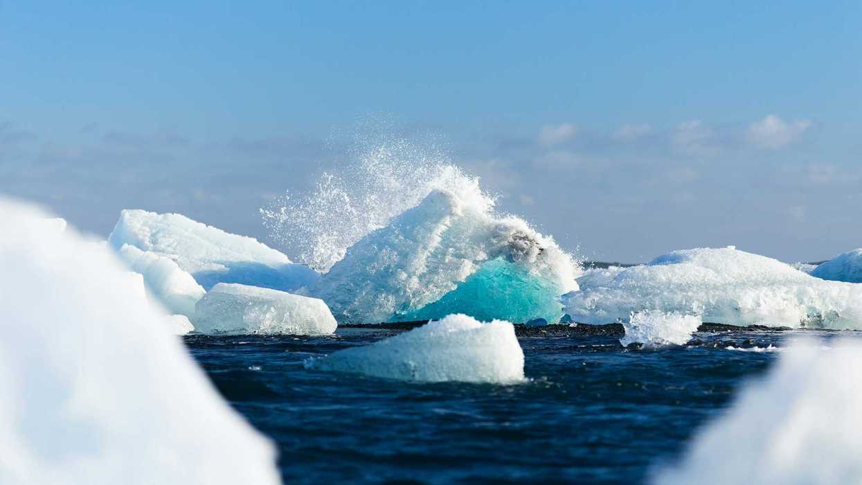 icebergs floating on body of water during daytime.
