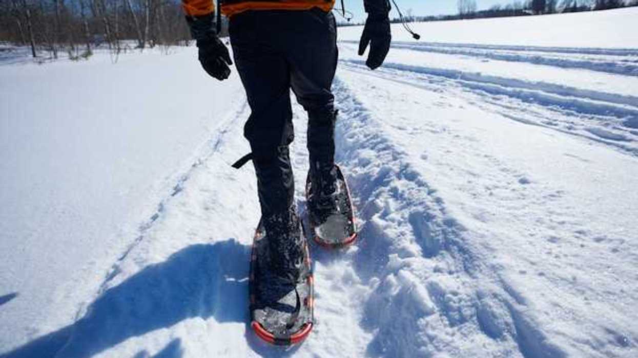 Image of a person snowshoeing in a snowy landscape