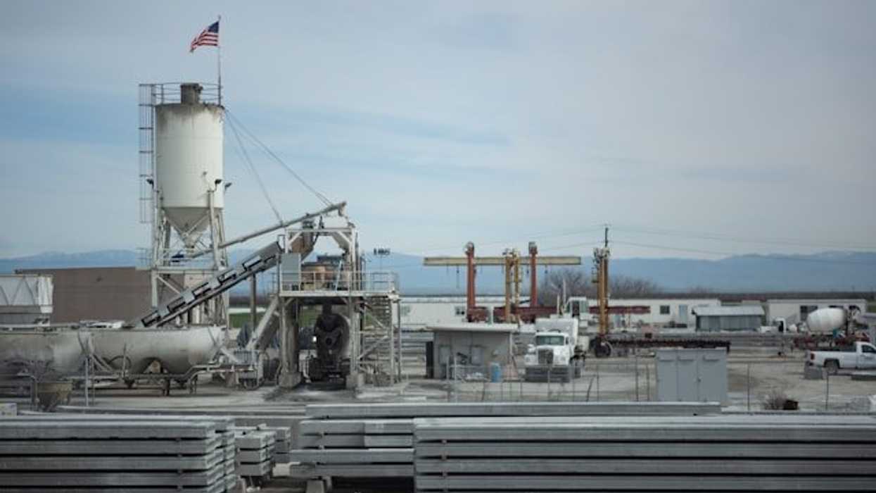 Industrial buildings and equipment on a cloudy day.