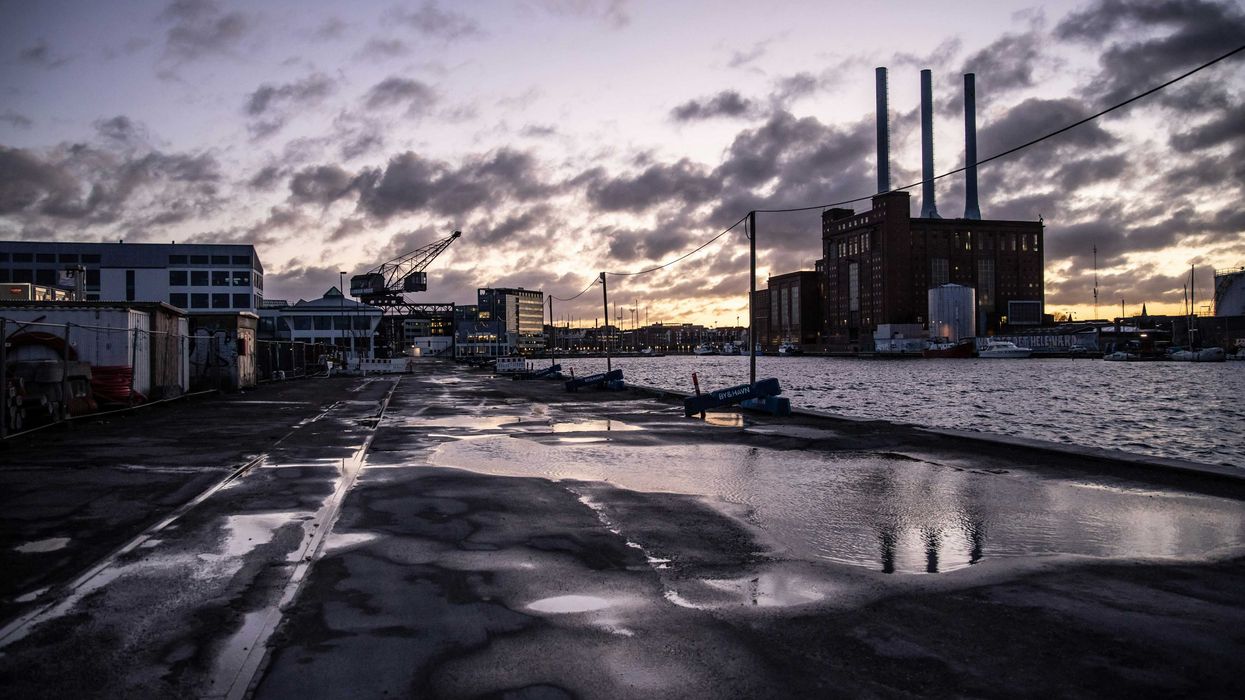 Industrial buildings next to the water at sunset