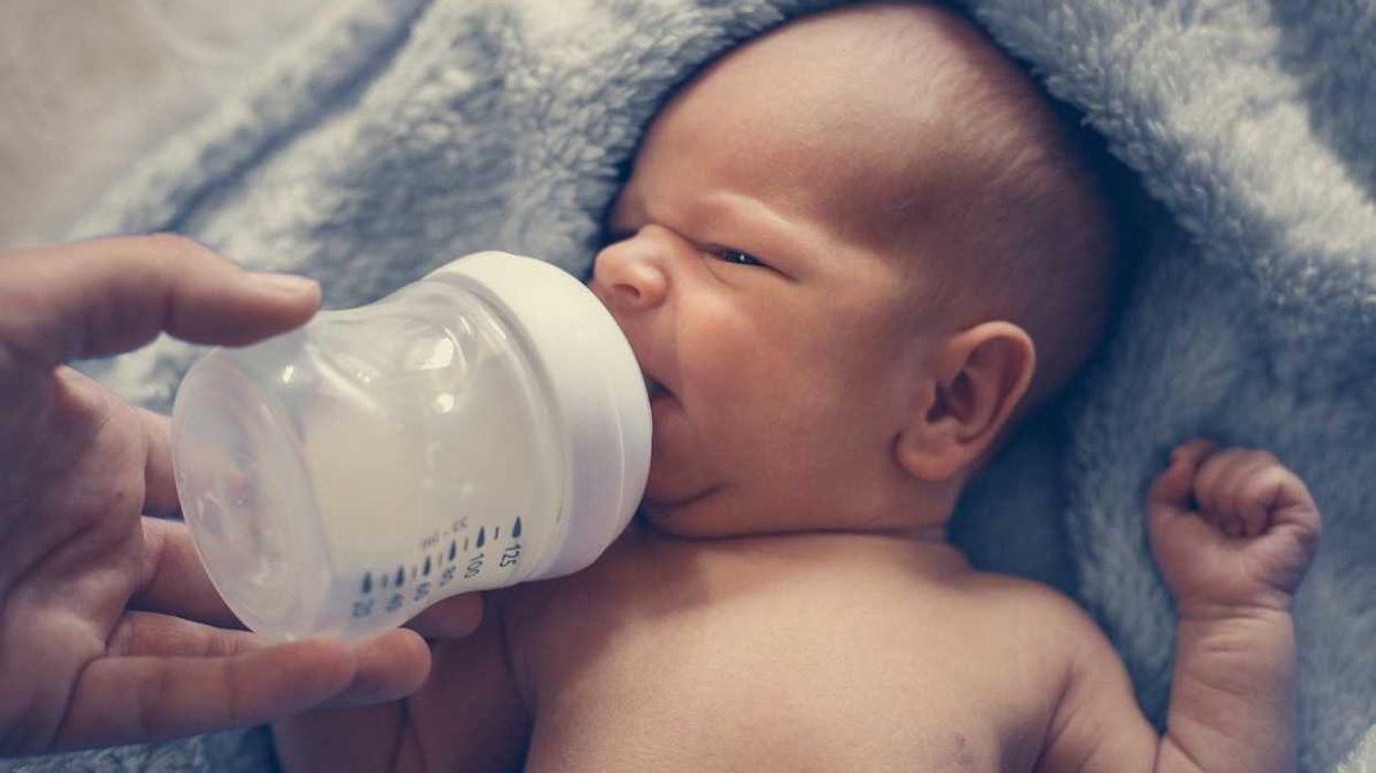 infant being bottle fed